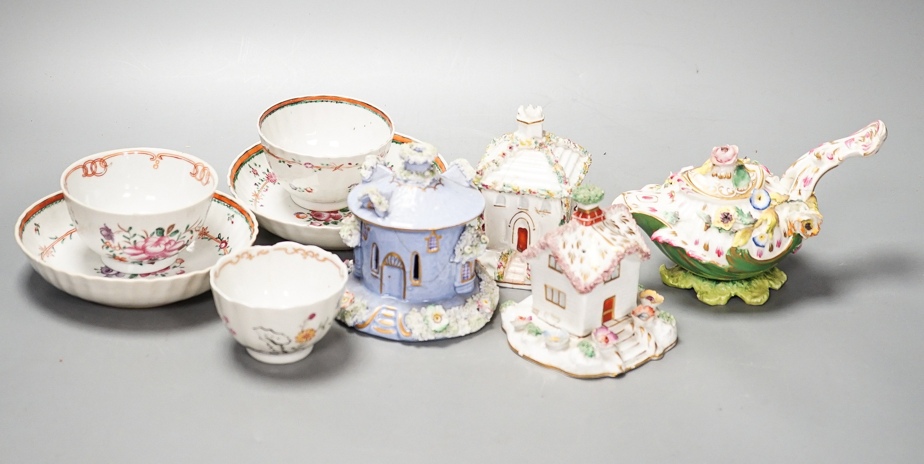 Three Chinese export famille rose tea bowls and two saucers, three Staffordshire porcelain cottage pastille burners and an English porcelain cream boat